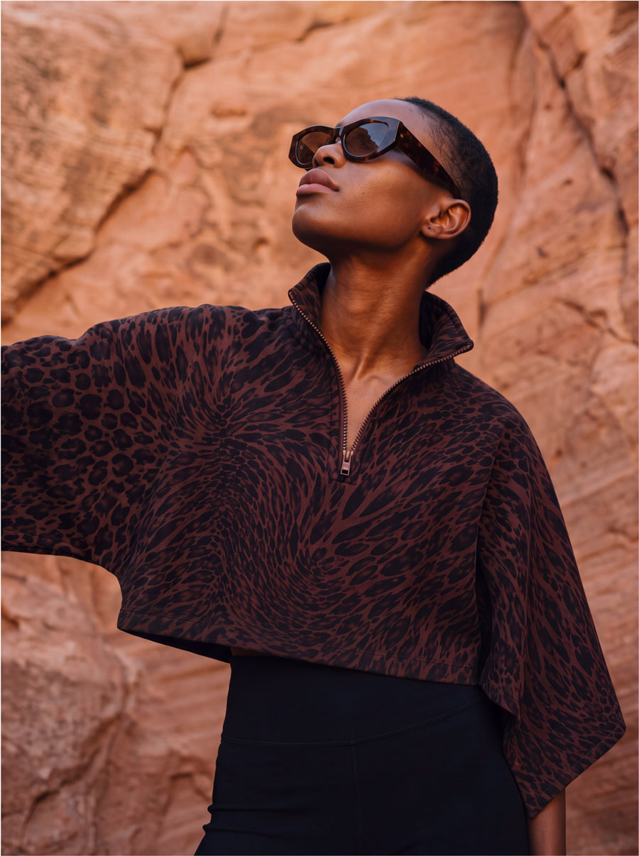 Sun Cape in leopard print, worn with black leggings